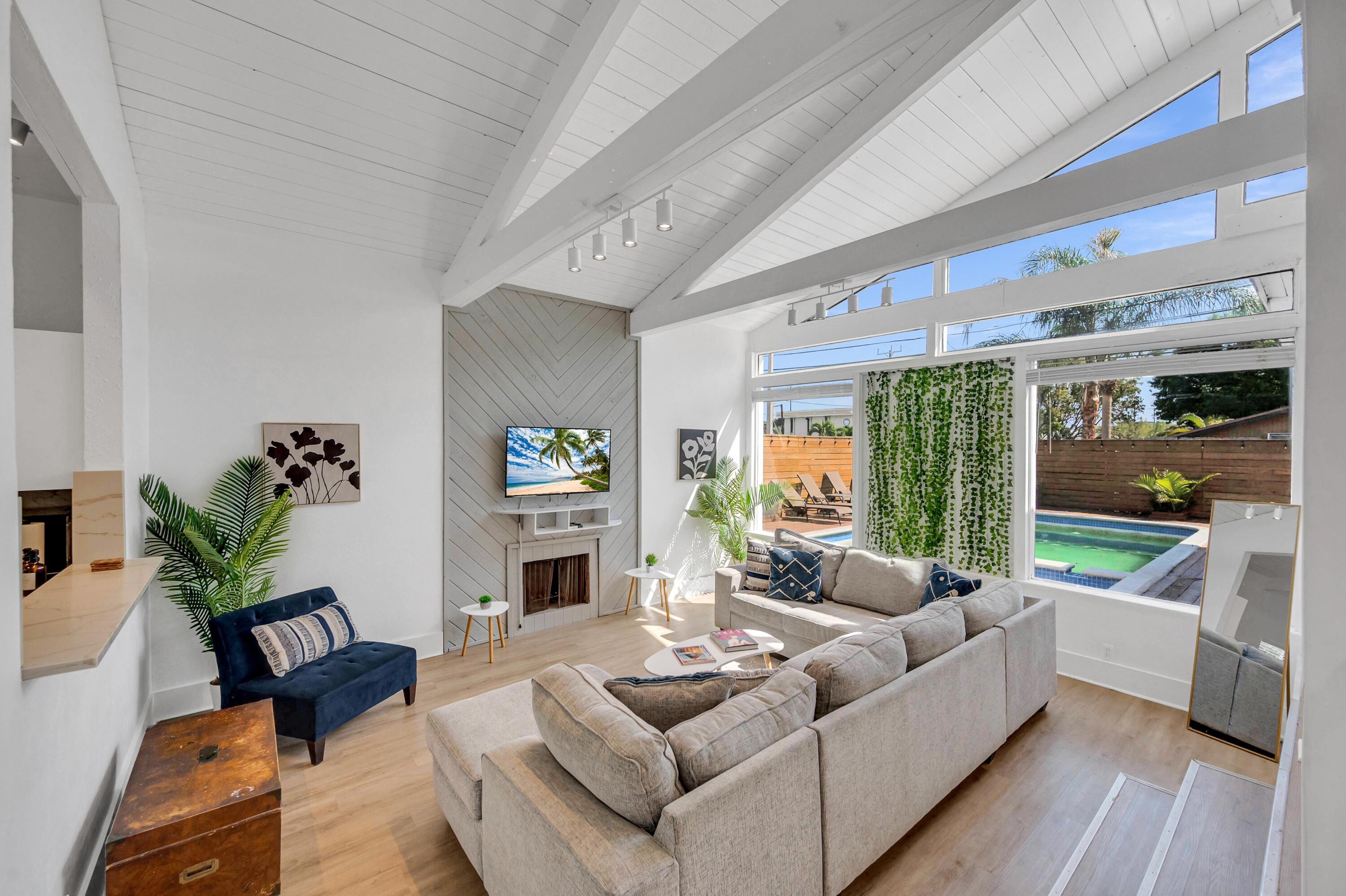 a living room with furniture fireplace and a large window