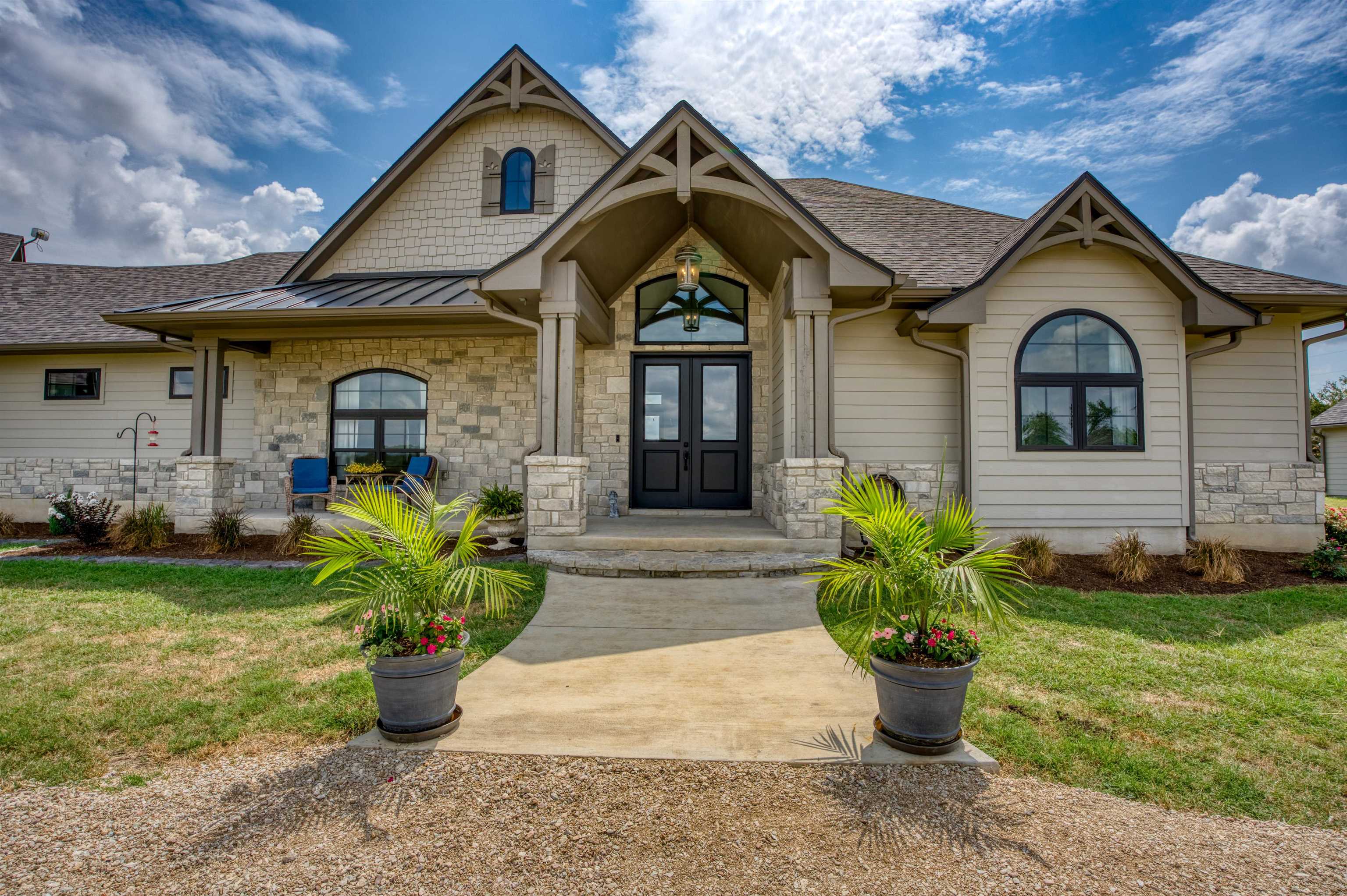 a front view of a house with a garden