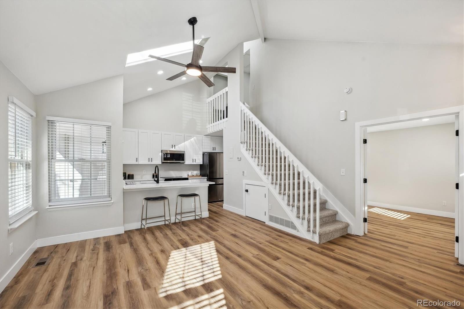 a view of a room with wooden floor and staircase