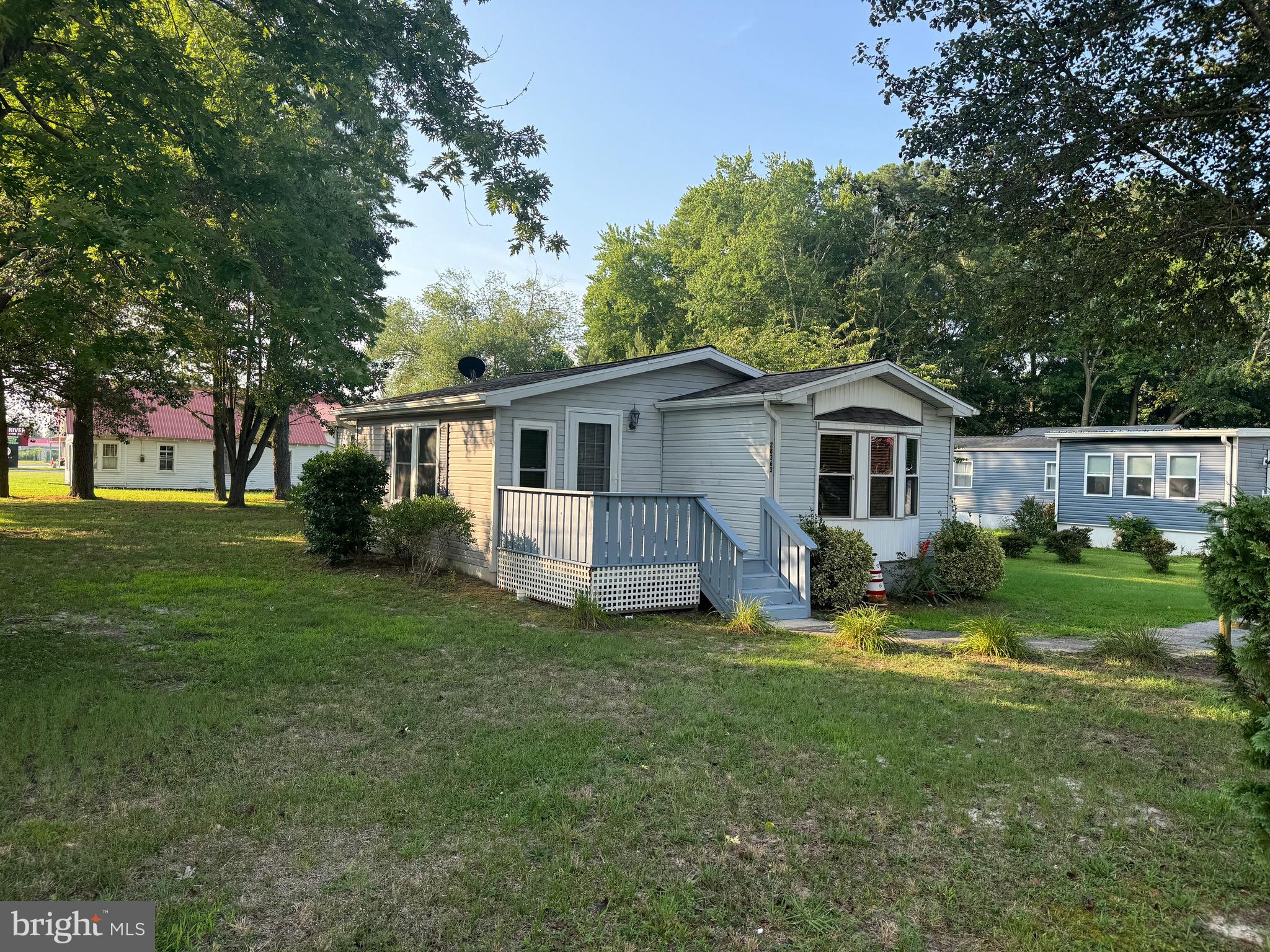 a view of a house with a yard and sitting area