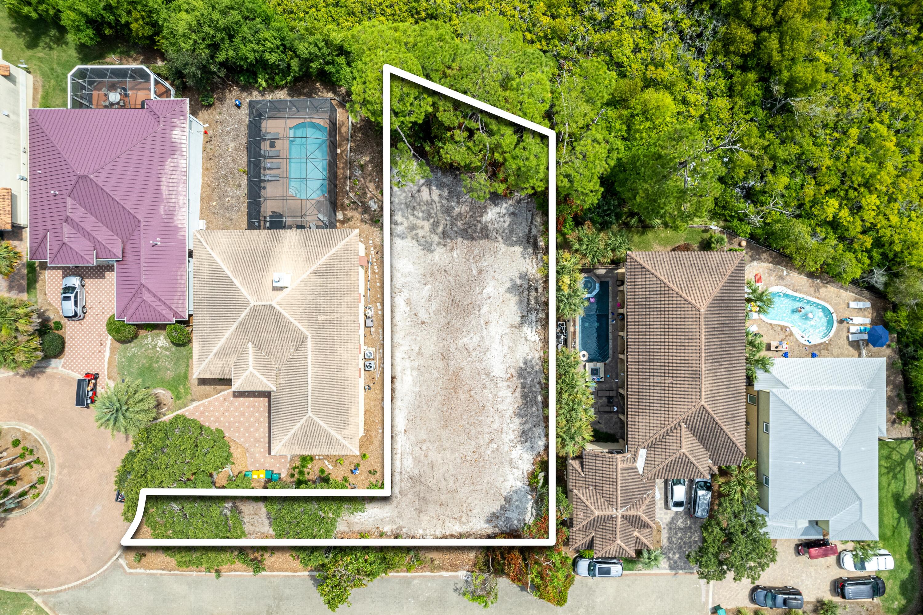 an aerial view of a house with a yard and large tree