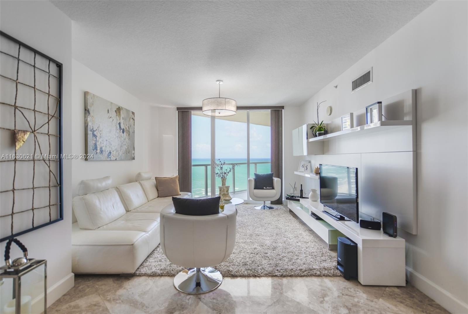 a living room with furniture a large window and a flat screen tv