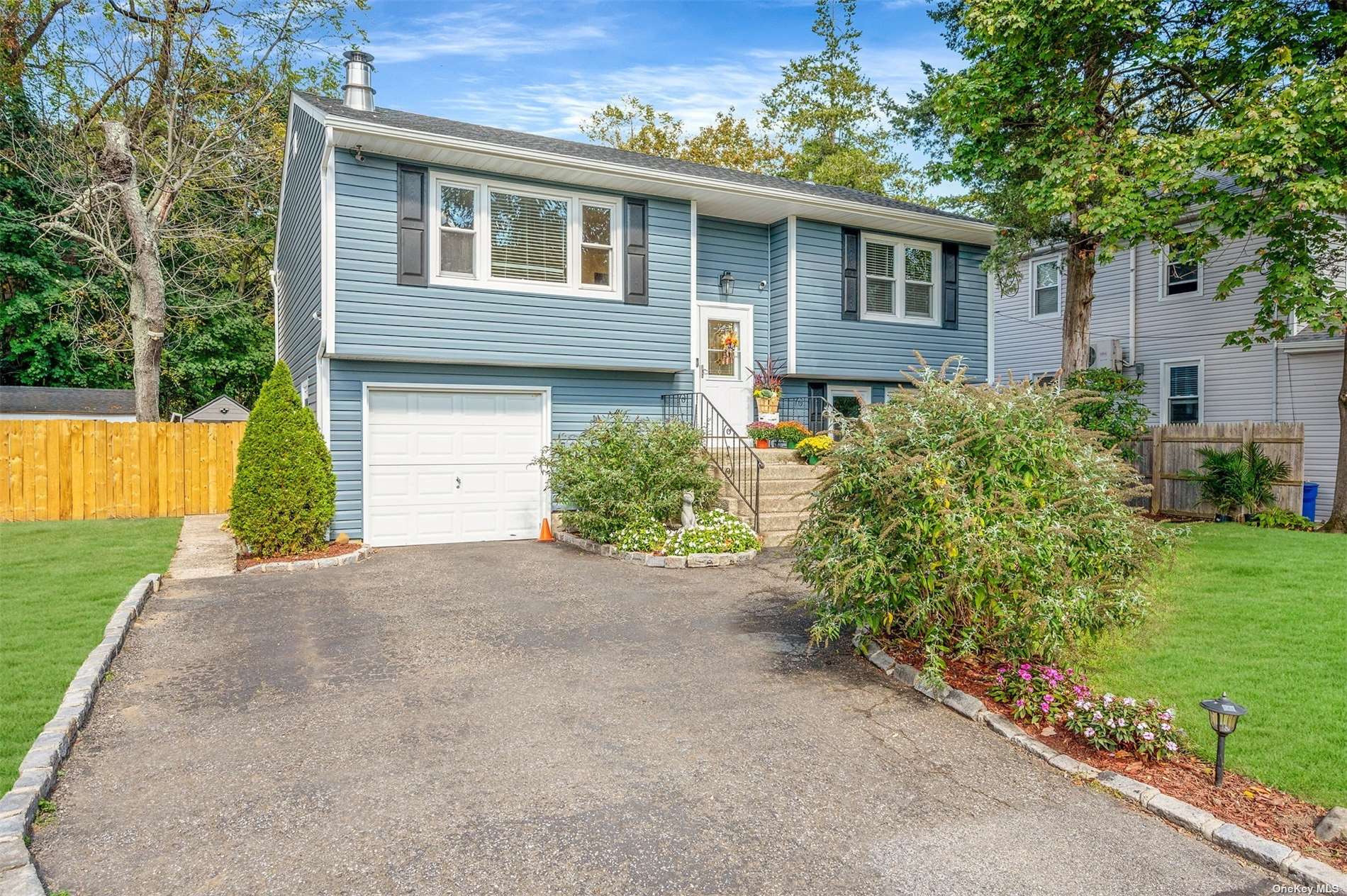 a front view of a house with a yard and potted plants