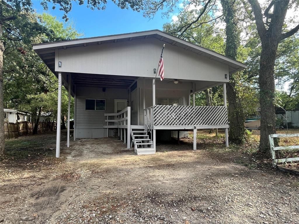 a front view of a house with a yard and deck