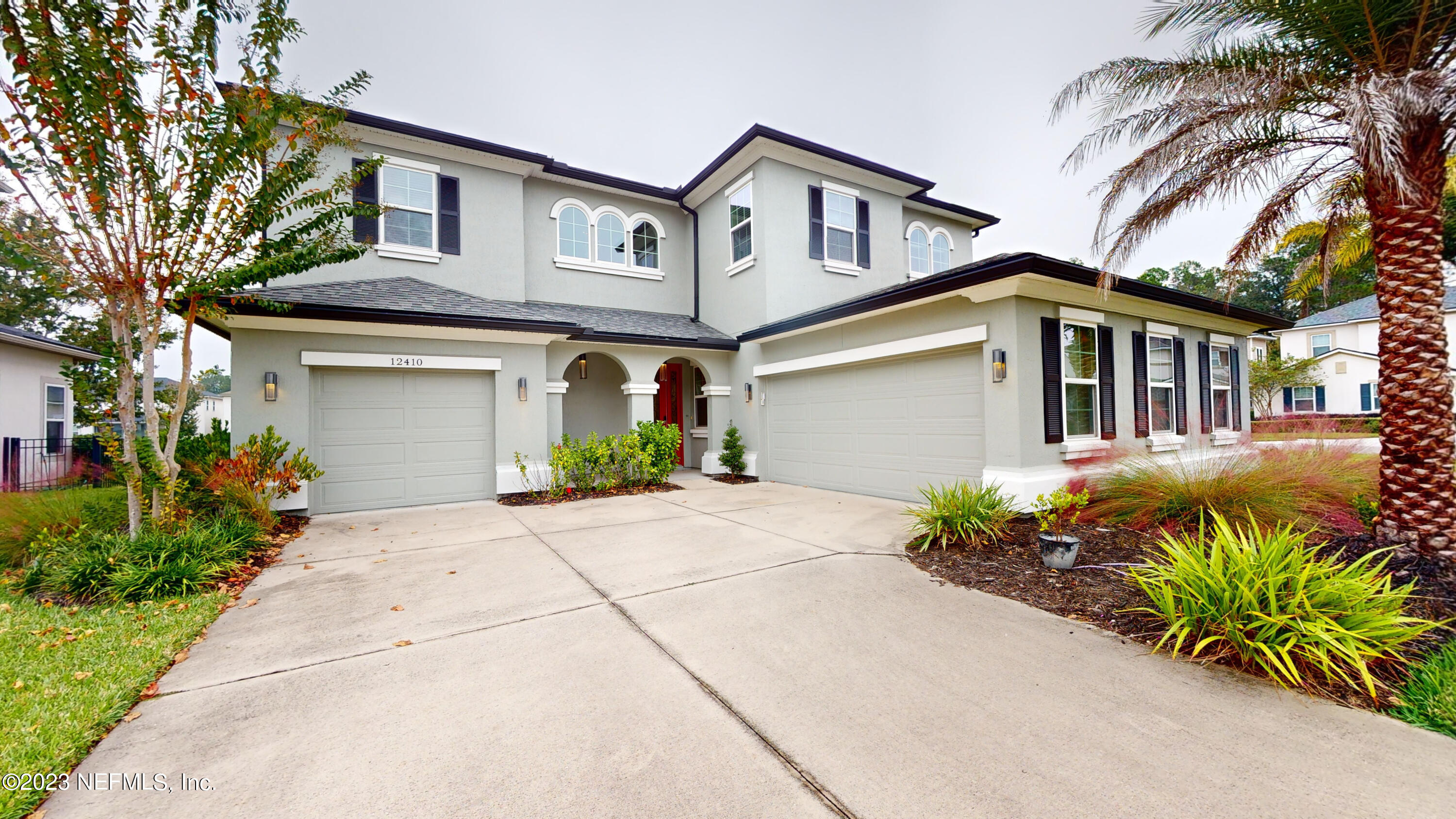 a front view of a house with a garden