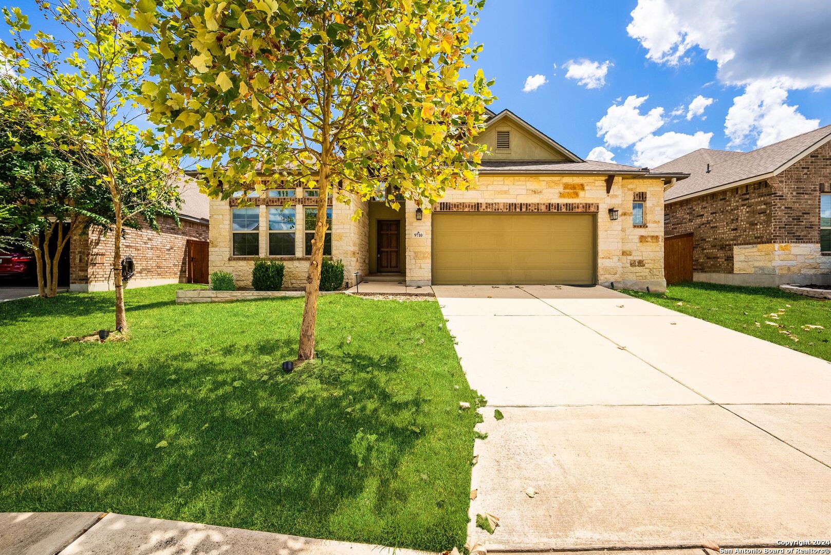 a front view of a house with a yard and garage