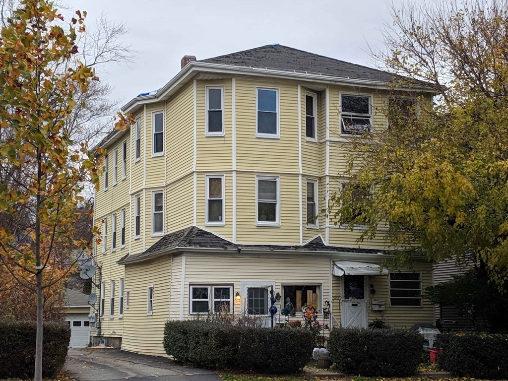 a front view of a house with a garden