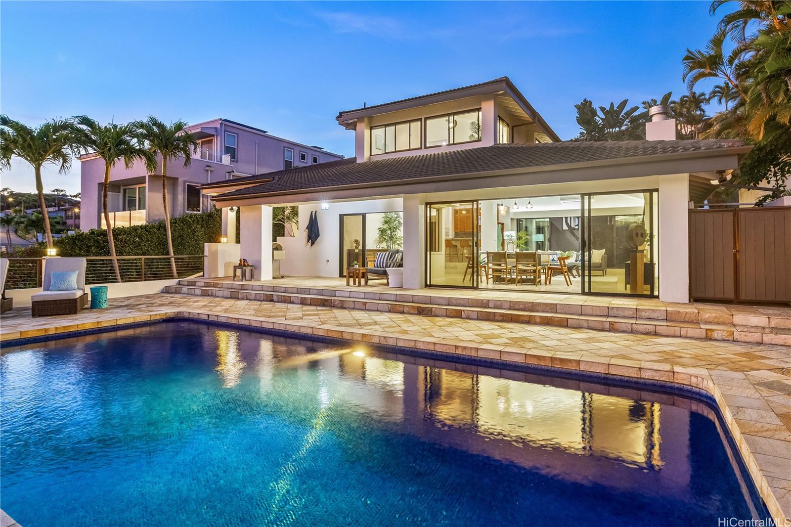 a view of a house with swimming pool and sitting area