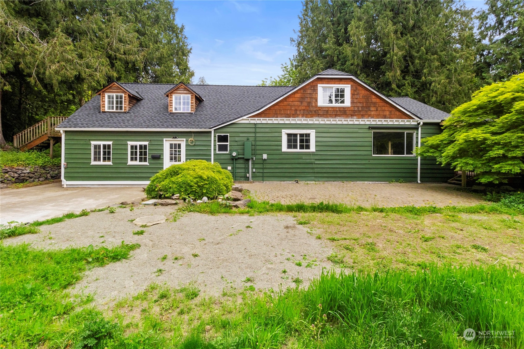 a front view of a house with garden