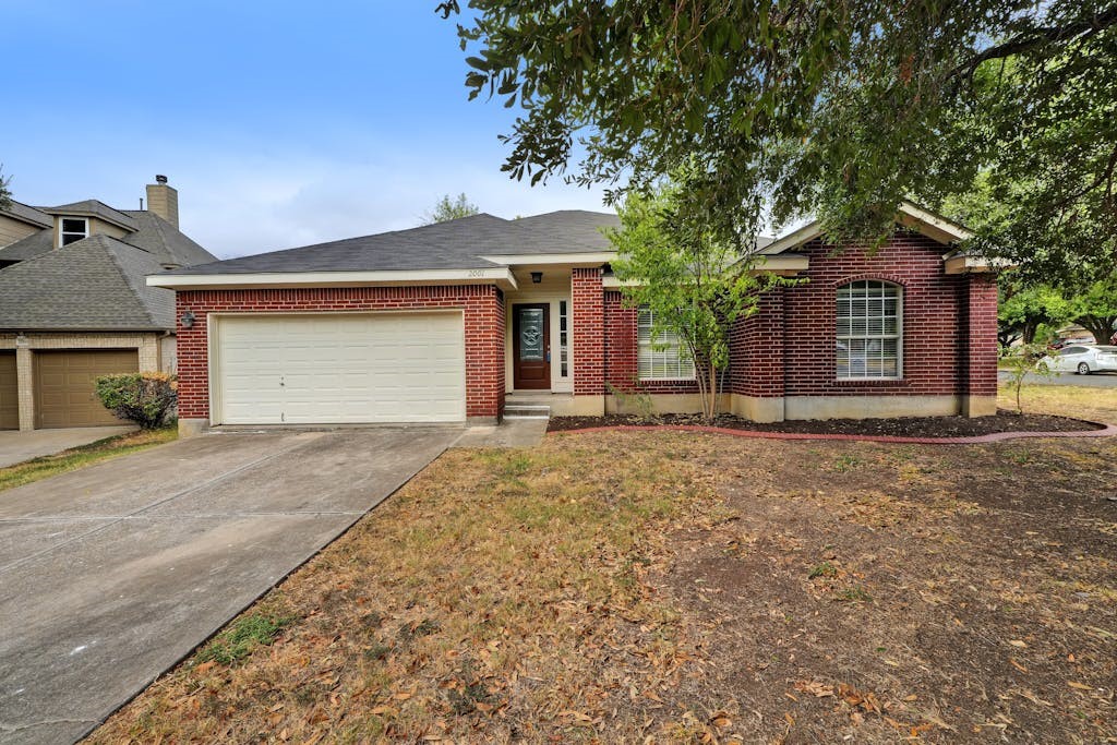 a front view of a house with a yard and garage