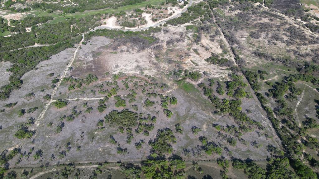 a view of a dry yard with lots of green space