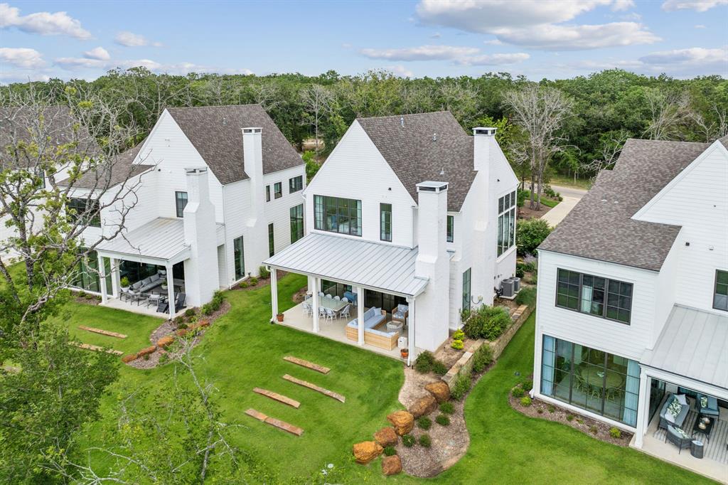 an aerial view of a house with a big yard