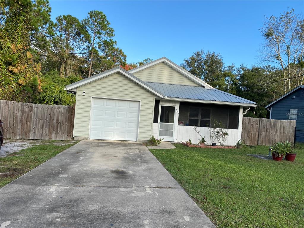 a front view of a house with a yard and a garage