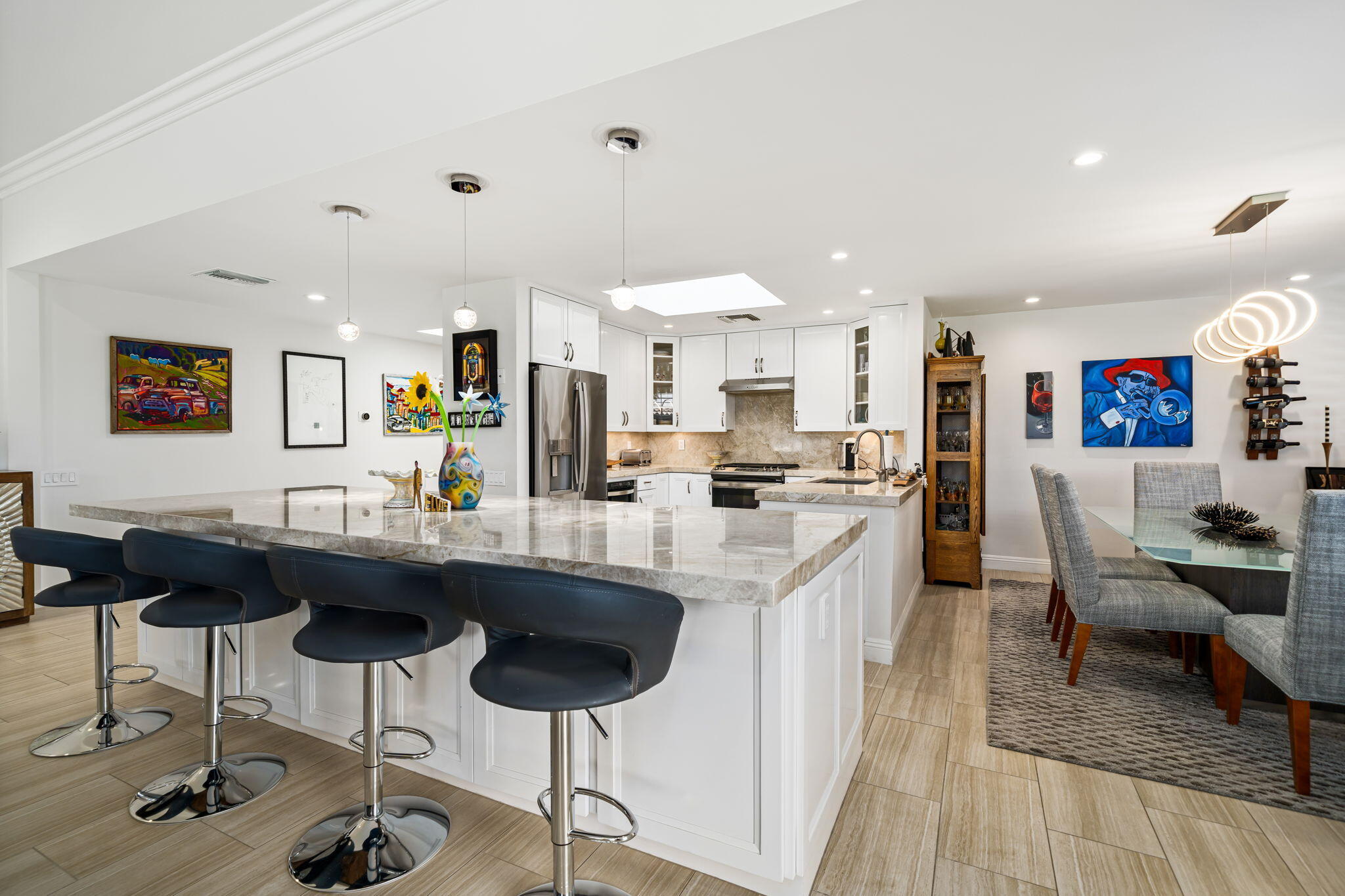 a kitchen with stainless steel appliances kitchen island granite countertop a sink and cabinets