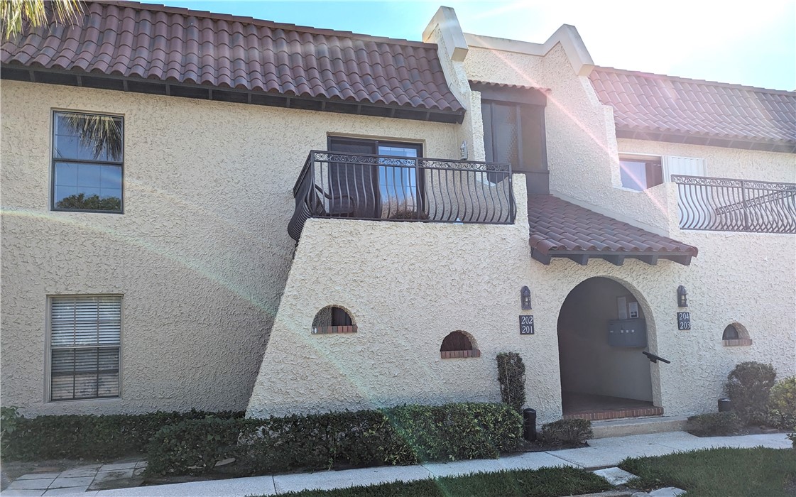 a front view of a house with plants