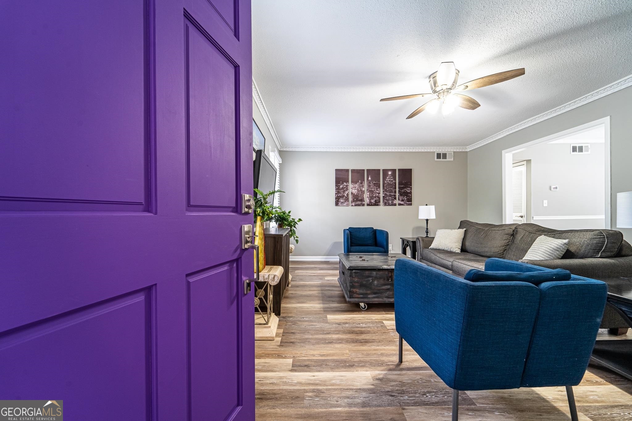 a living room with furniture a ceiling fan and a window