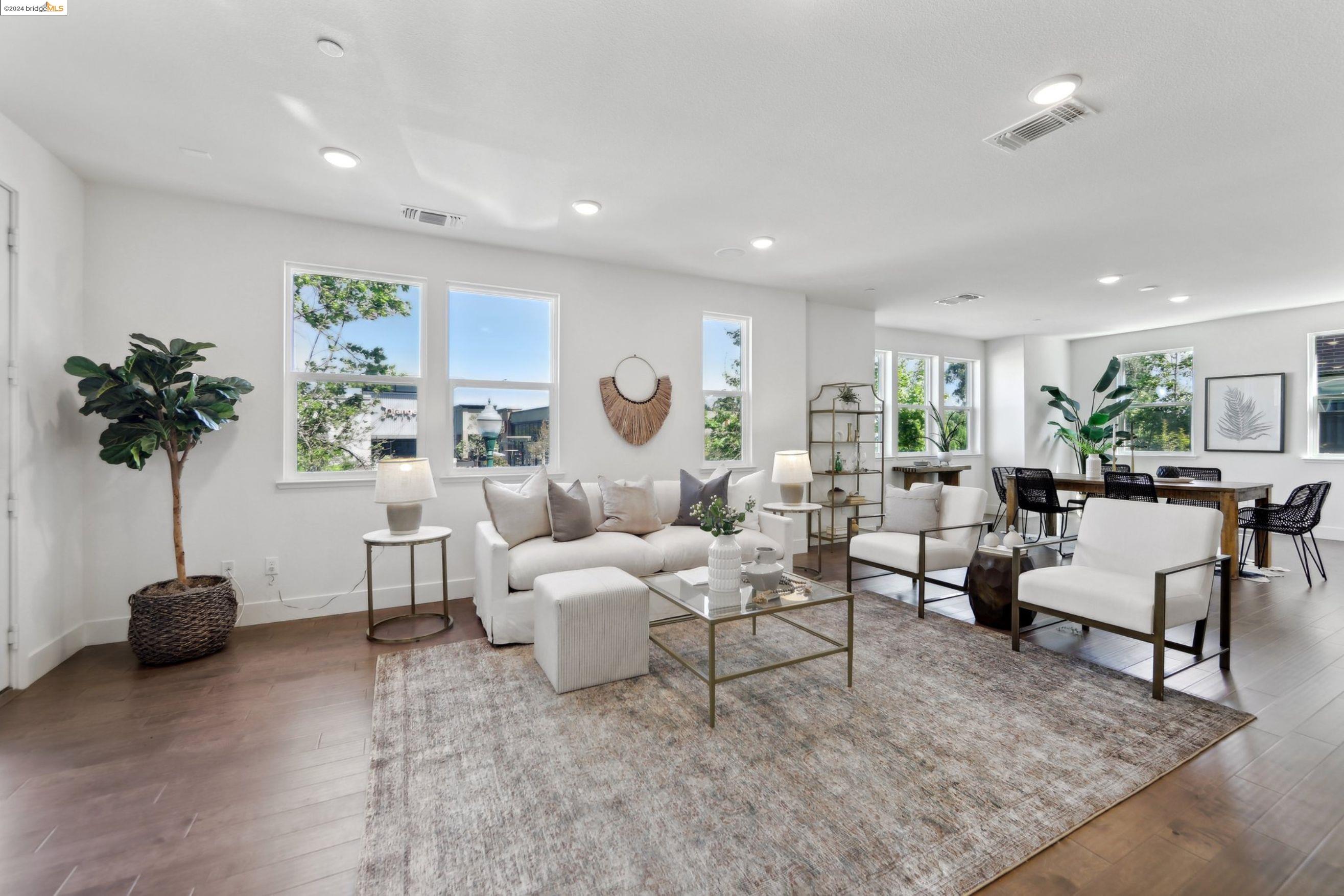 a living room with furniture a table and a potted plant