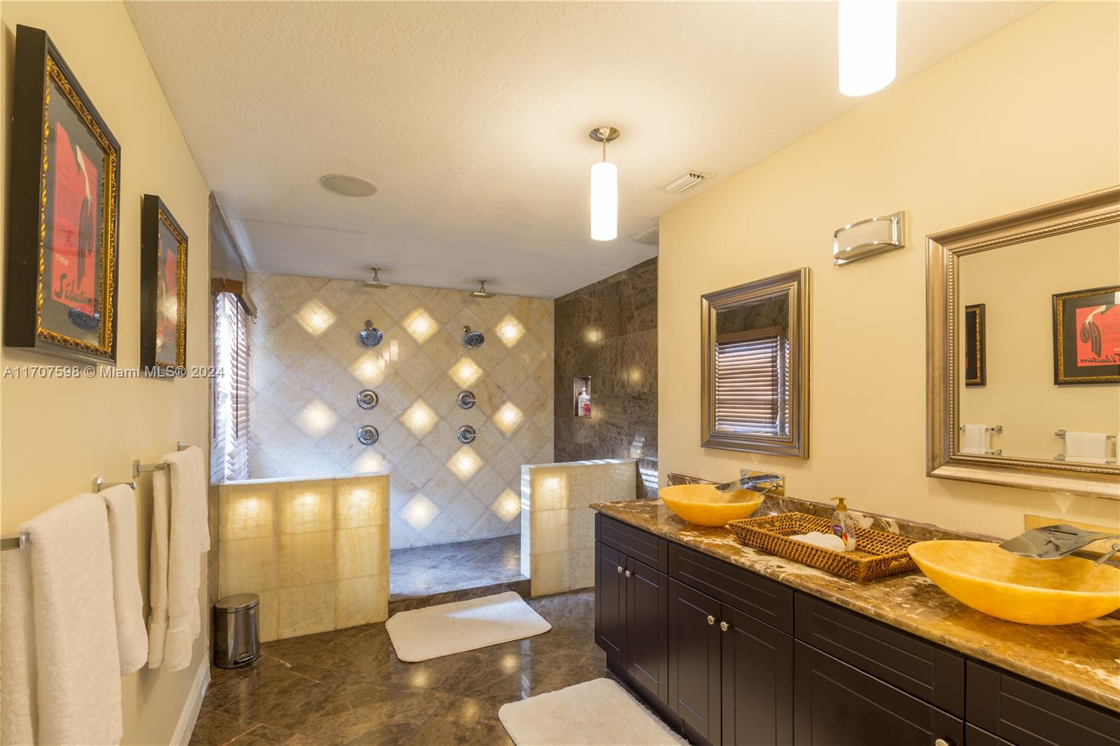 a spacious bathroom with a sink a large mirror and a shower