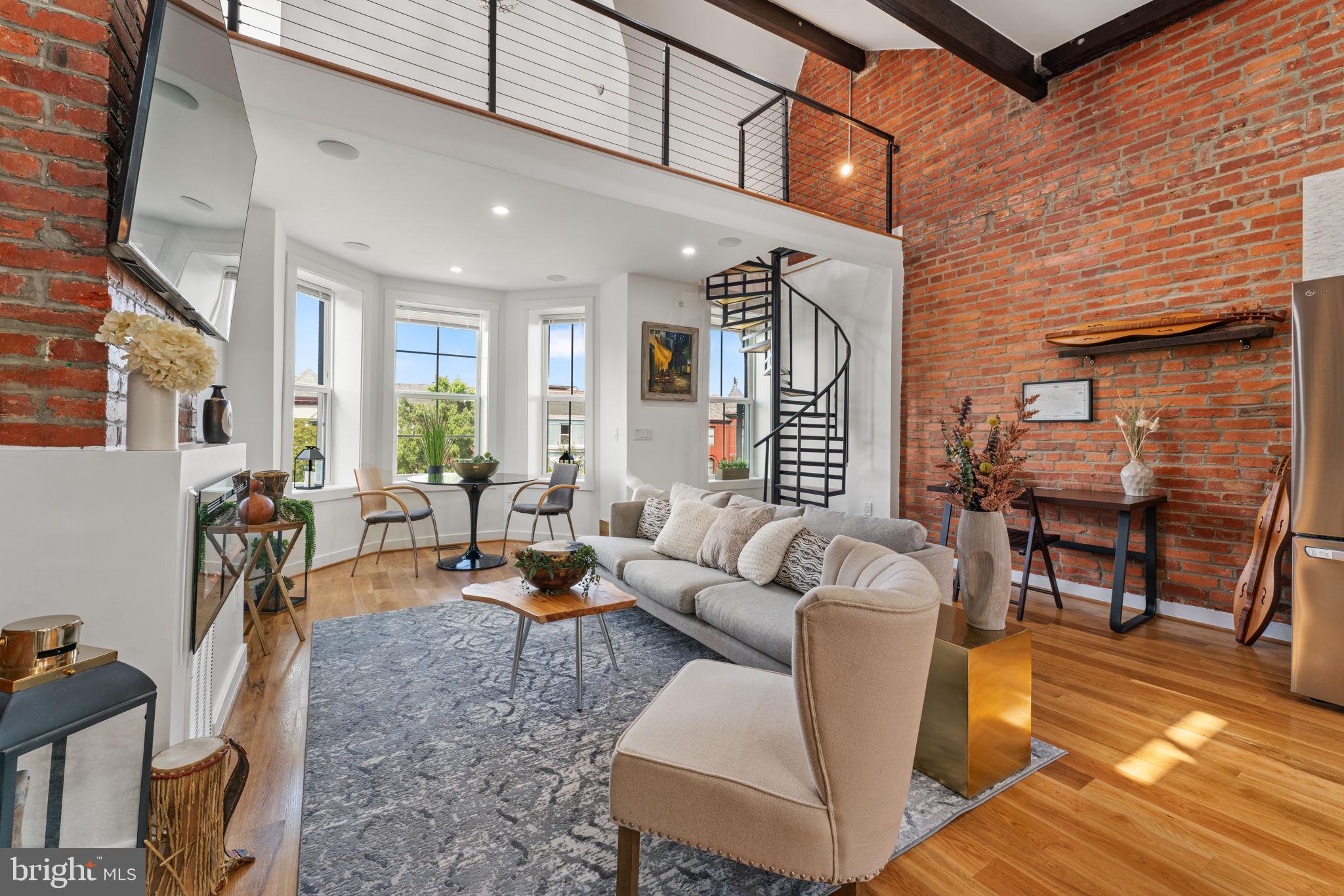 a living room with furniture a dining table and chairs with wooden floor