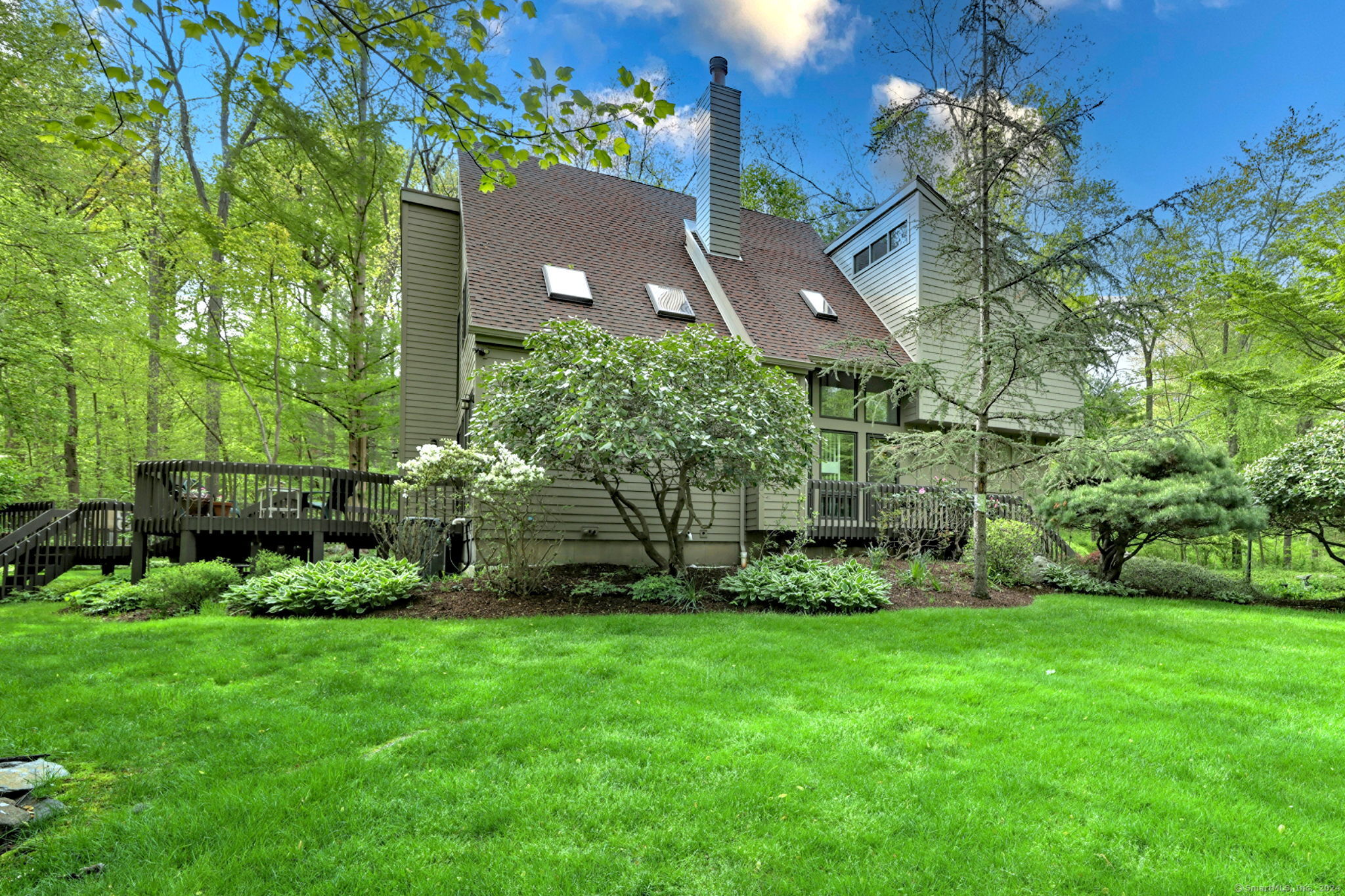 a view of a house with a yard and garden