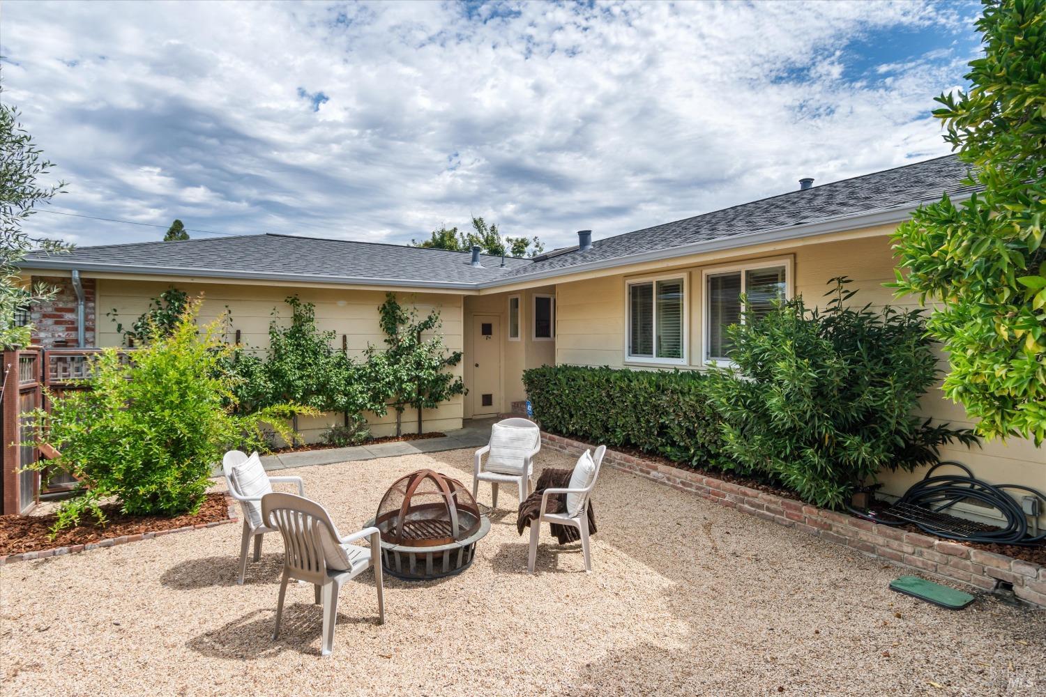 a view of a patio with table and chairs and potted plants