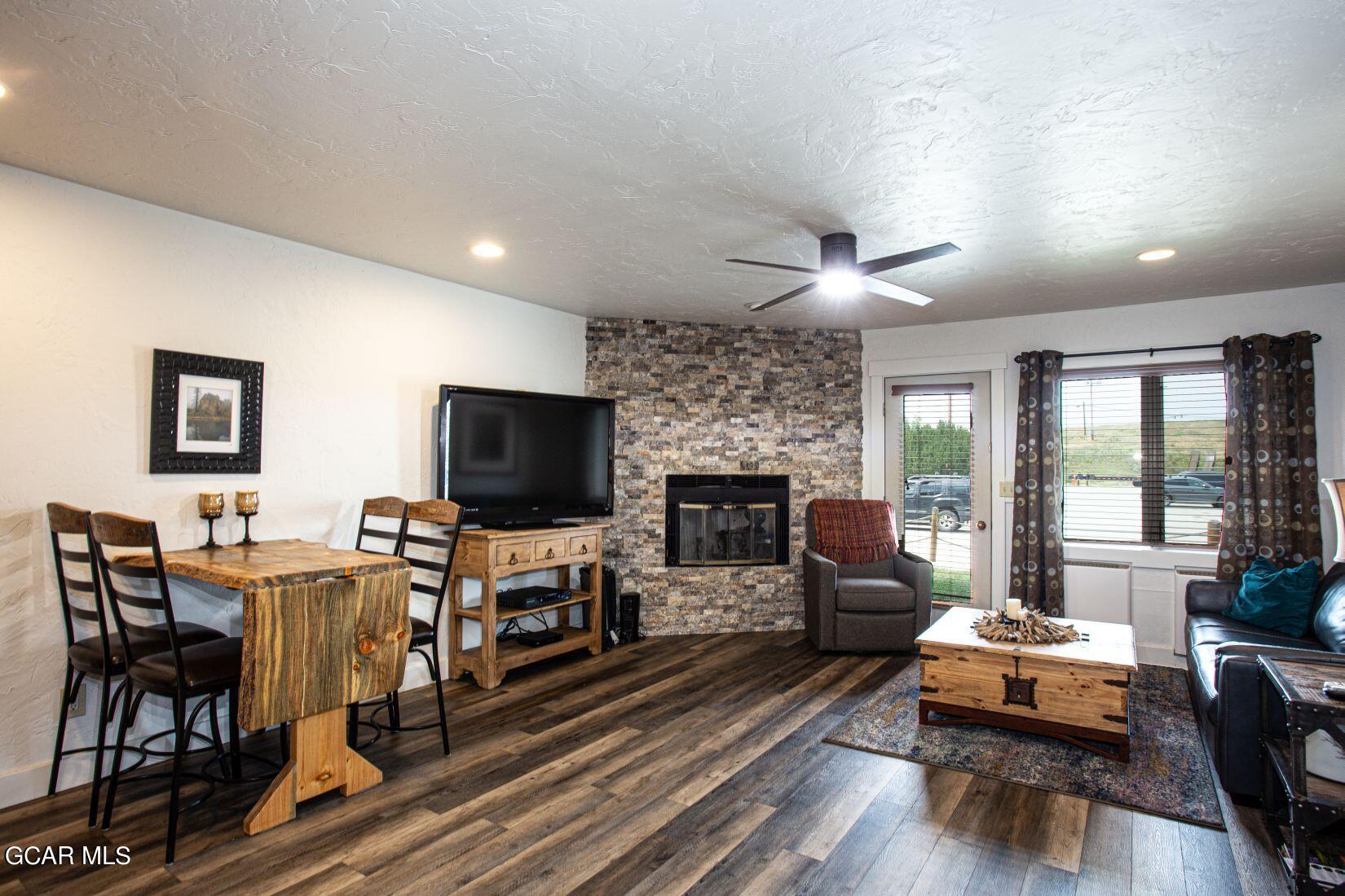 a living room with fireplace furniture and a flat screen tv