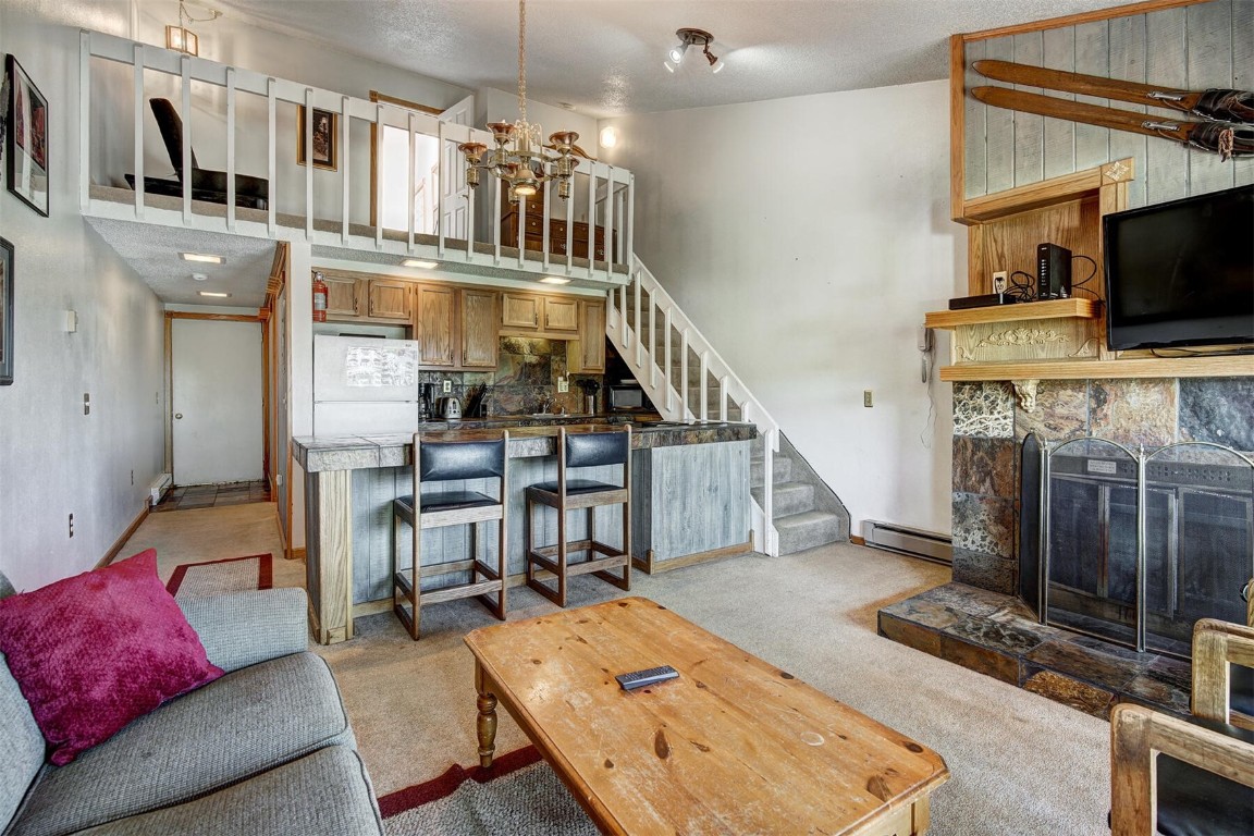 a living room with fireplace furniture and a flat screen tv