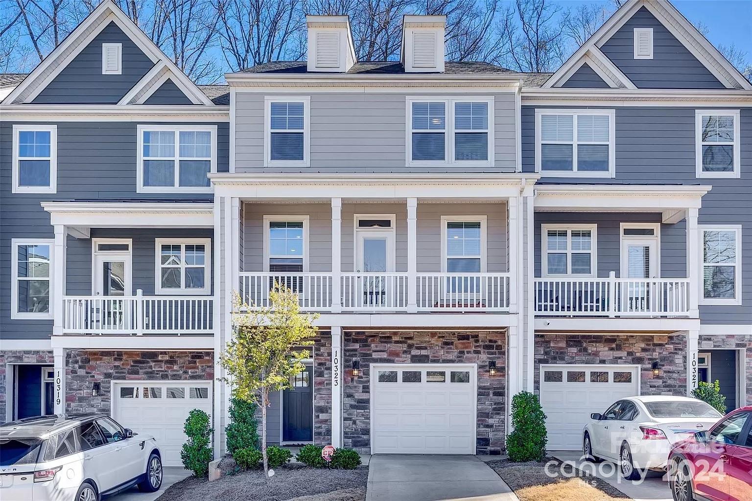 a front view of a residential apartment building with a yard