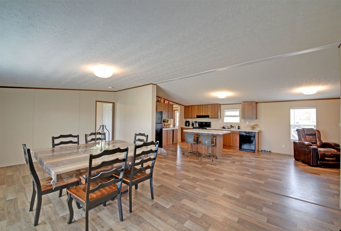 a view of a dining room with furniture and a kitchen