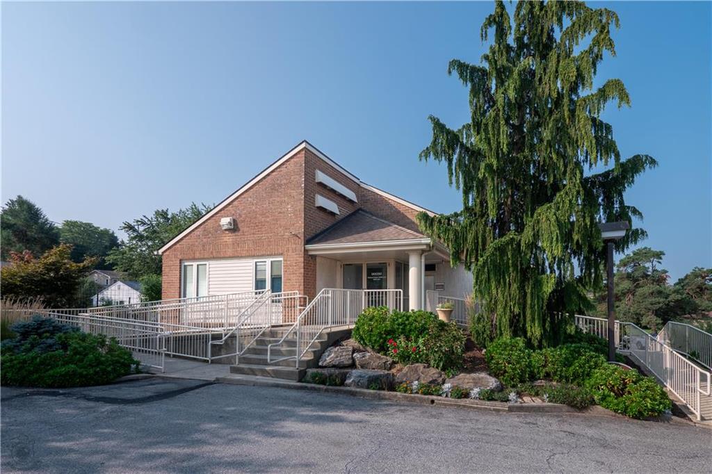 a front view of a house with a garden