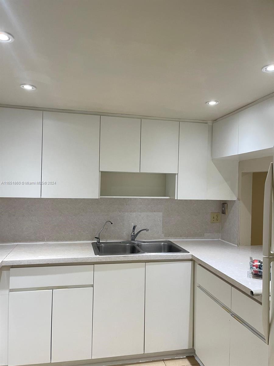 a kitchen with a sink and cabinets