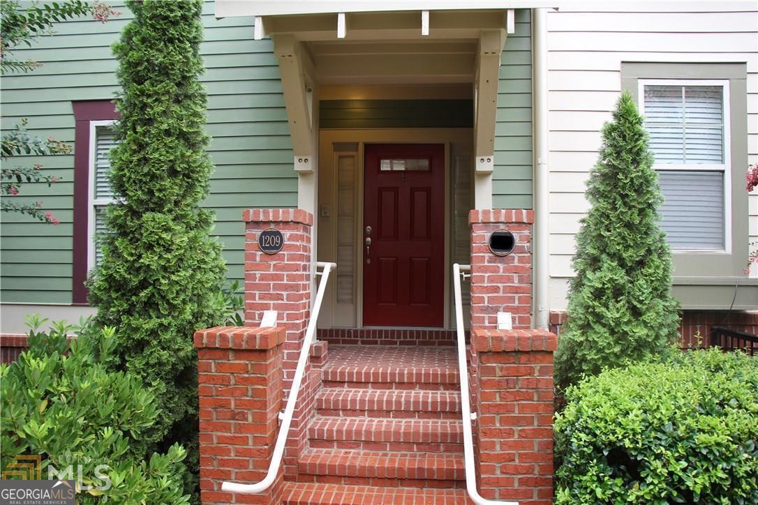 a front view of a house with a garden