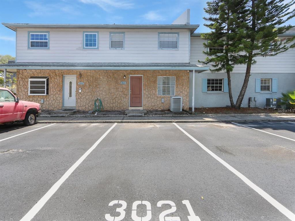 a front view of a house with a road