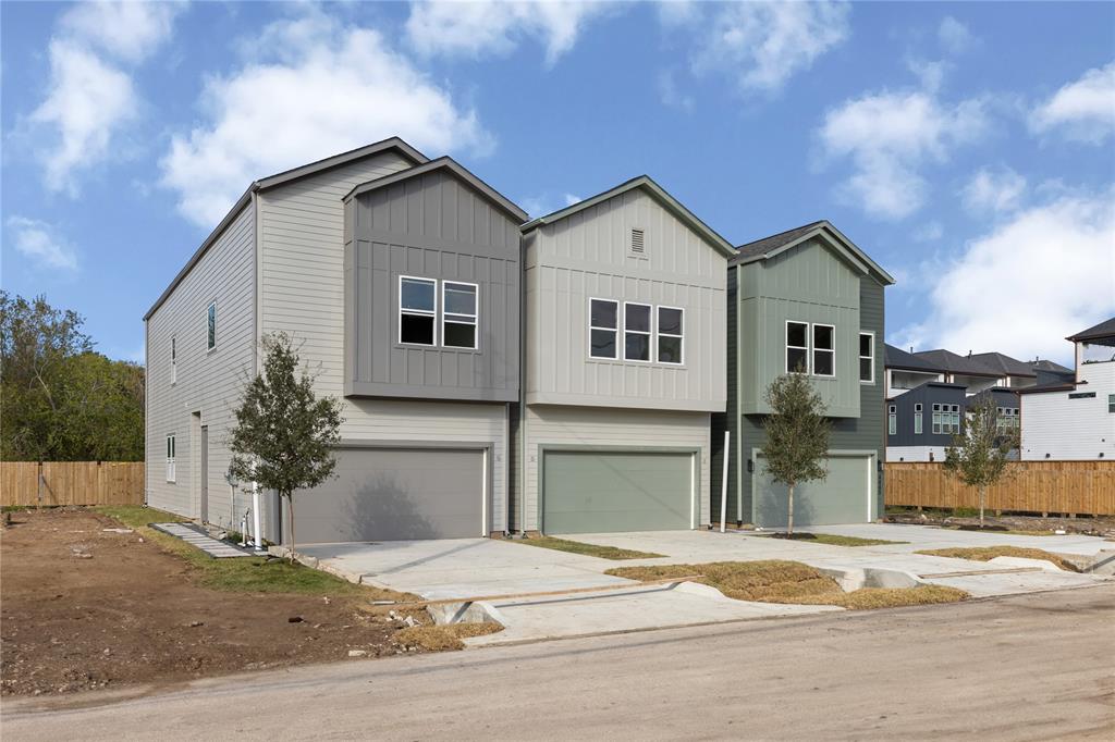 a view of a house with a yard and garage