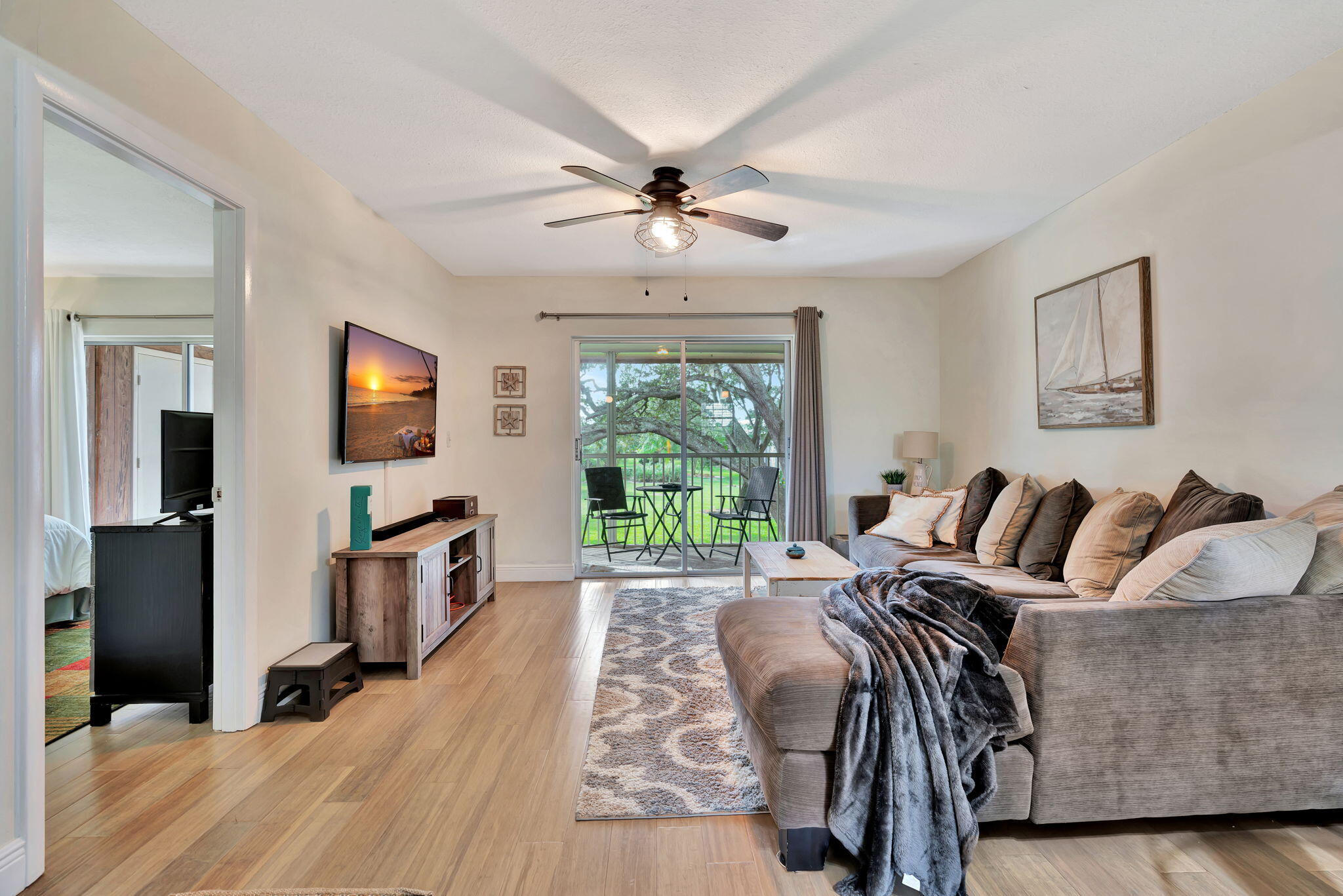 a bedroom with furniture and a flat screen tv