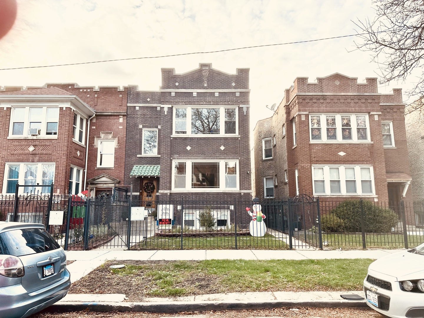 a view of a brick building next to a yard