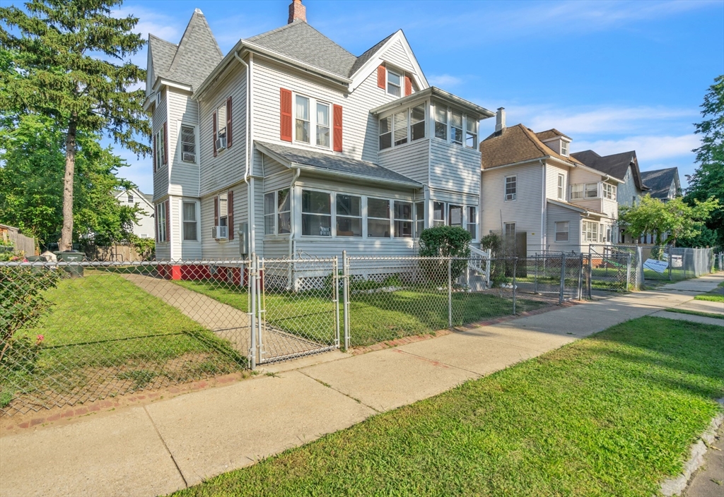 a view of a house with a yard and plants