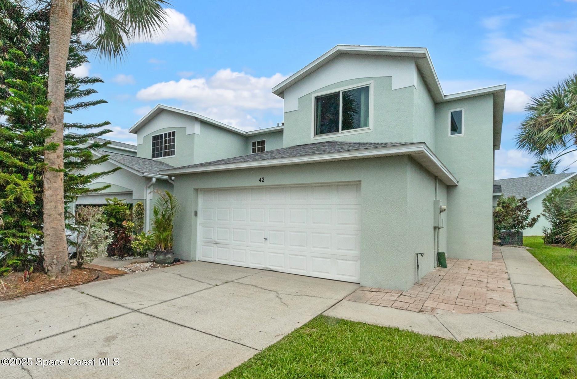 a front view of a house with a garage