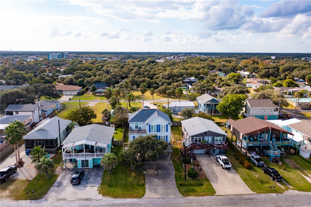 an aerial view of multiple houses with a yard