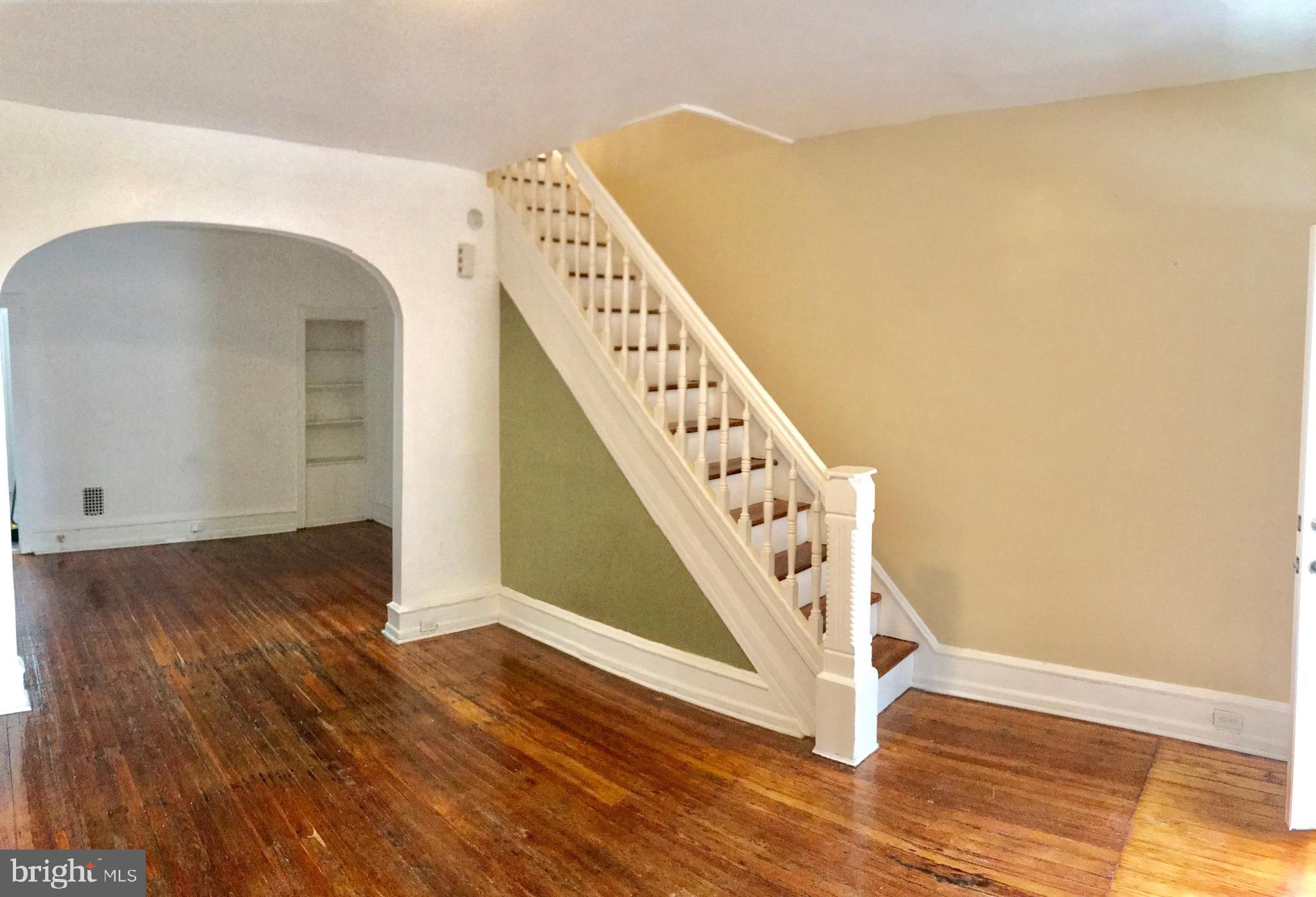 a view of an entryway with wooden floor