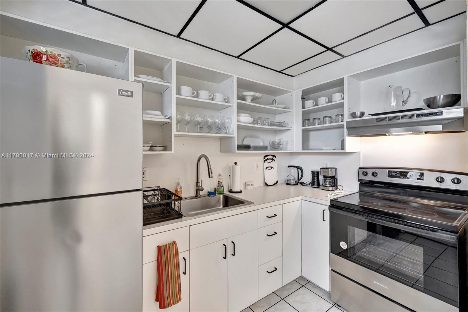 a kitchen with stainless steel appliances a sink and cabinets