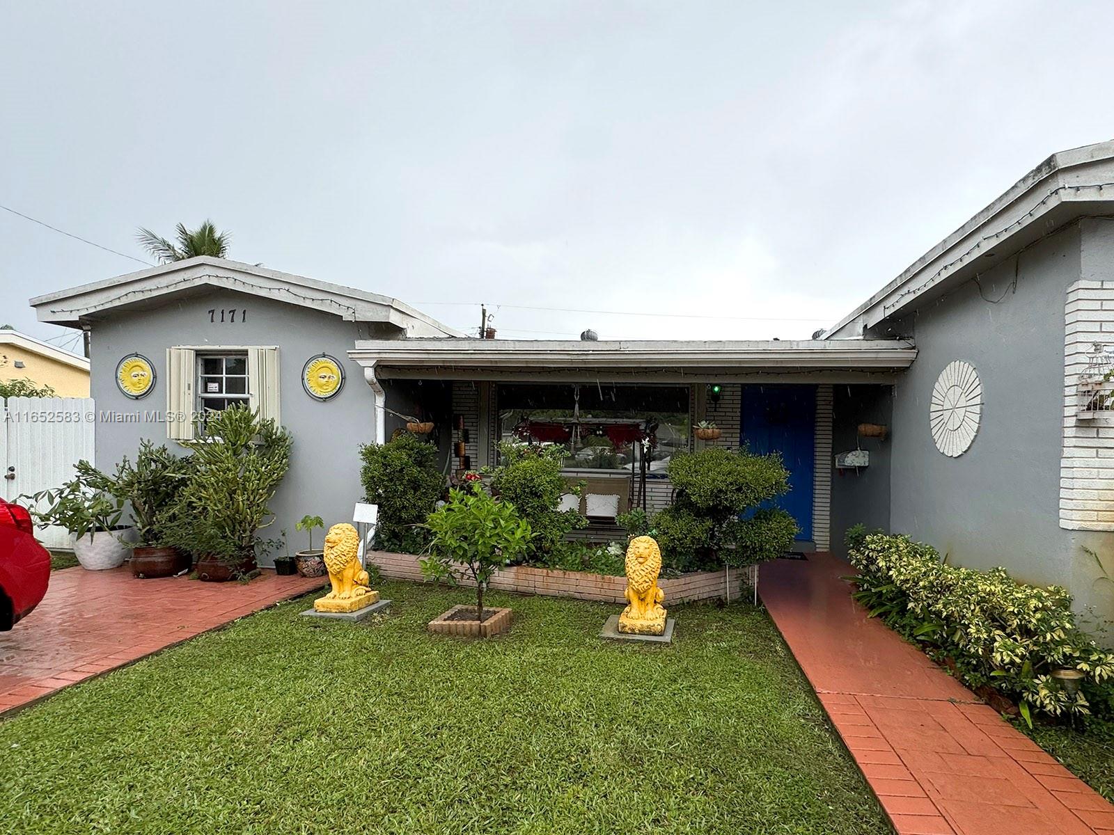 a front view of a house with garden