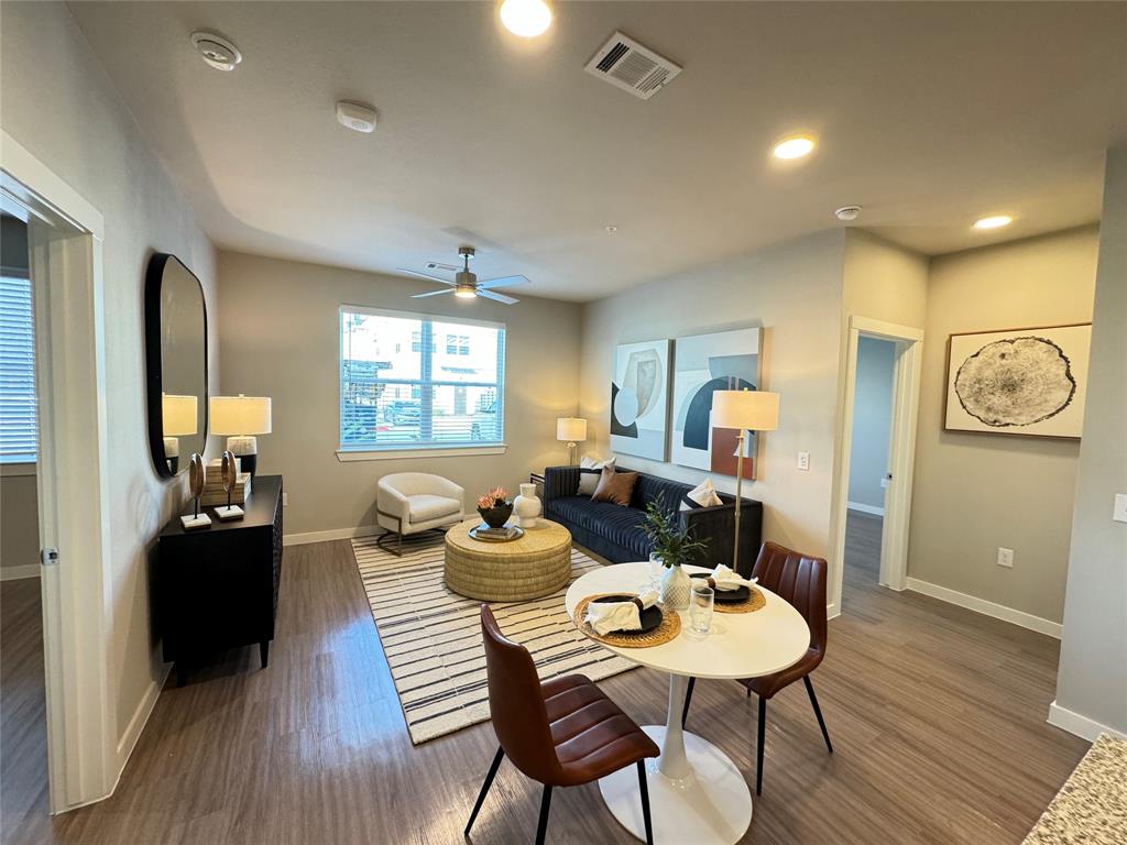 a view of a dining room with furniture window and wooden floor