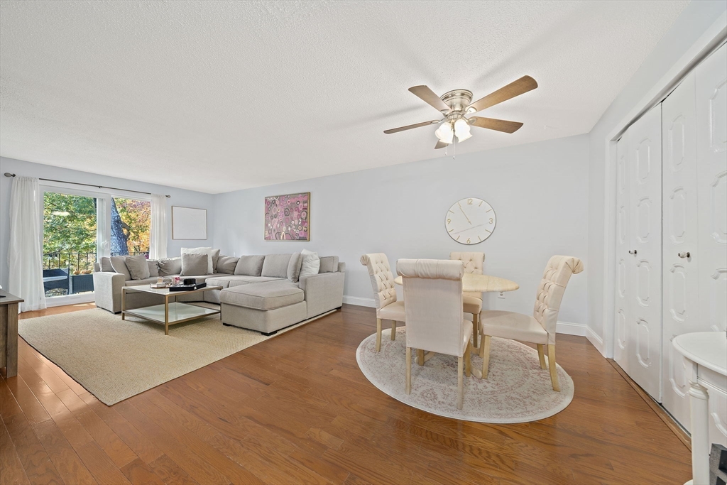 a living room with furniture a large window and a chandelier