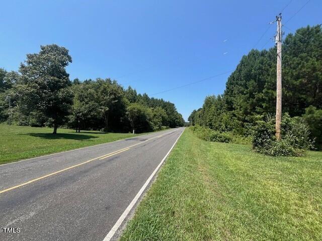 a view of a road with a yard