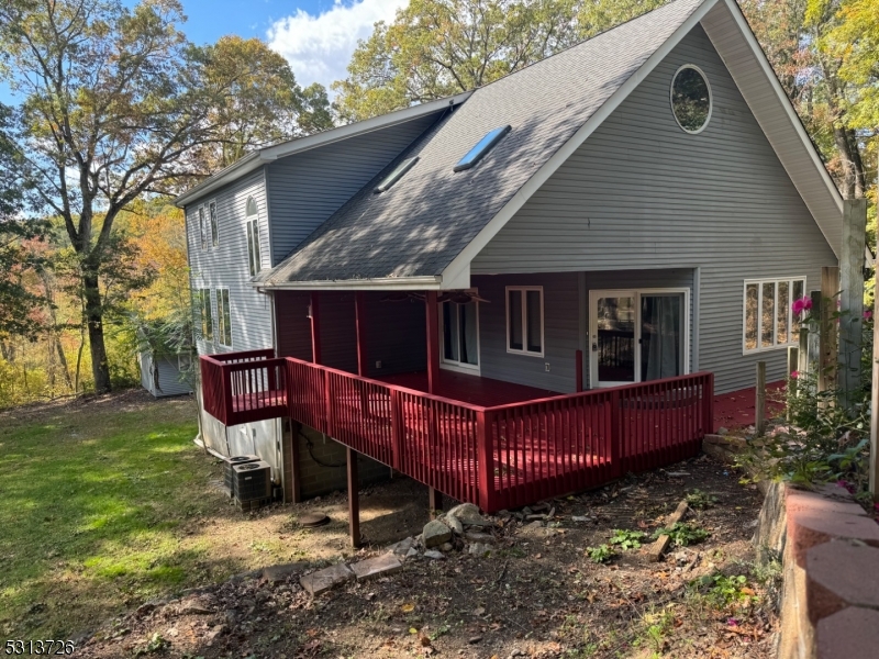 a view of a house with a yard chairs and a fence