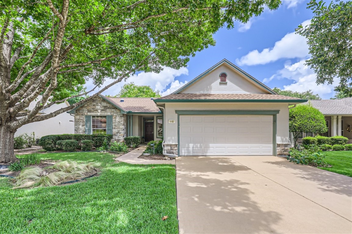 A magnificent Red Oak tree greets you and notice a well-manicured yard