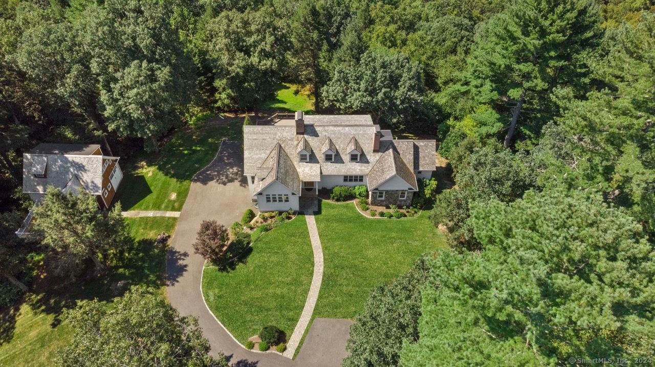 an aerial view of a house with a yard