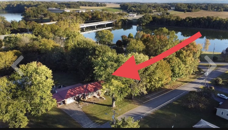 an aerial view of lake and houses with outdoor space