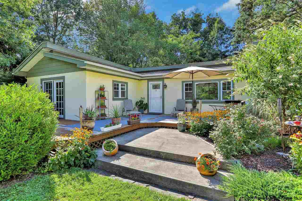 a view of house with backyard outdoor seating and green space